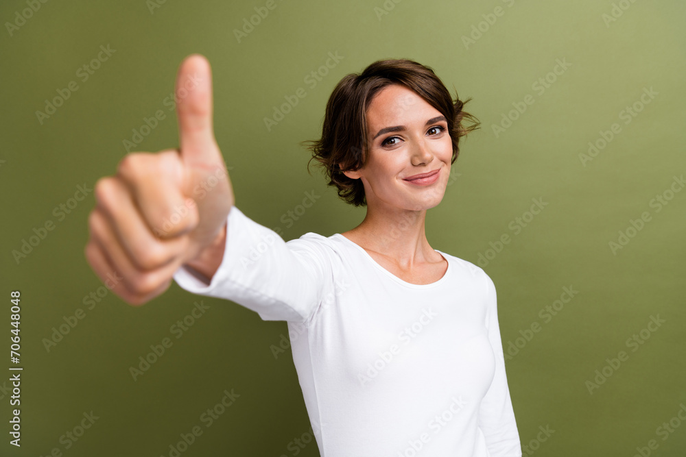 Portrait of cheerful girl expert raising thumb finger up agree confirm good product quality isolated khaki green color background Portrait of cheerful girl expert raising thumb finger up agree confirm good product quality isolated khaki green color background