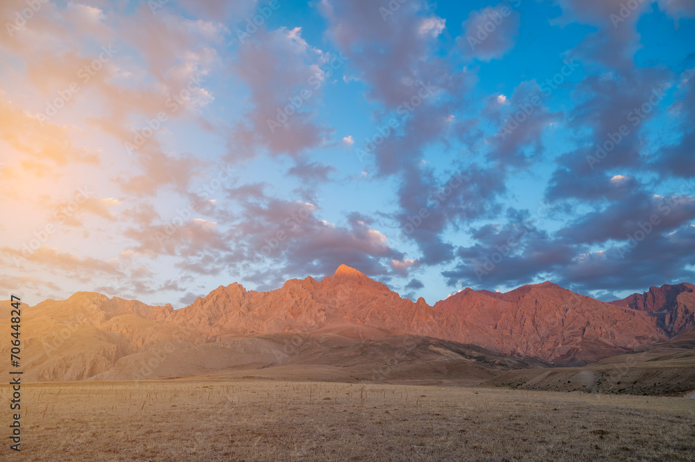 Red mountains the extension of the Taurus Mountains the harmony of the sunset coloured clouds and the steep rocks of its surroundings with the sky and sun light