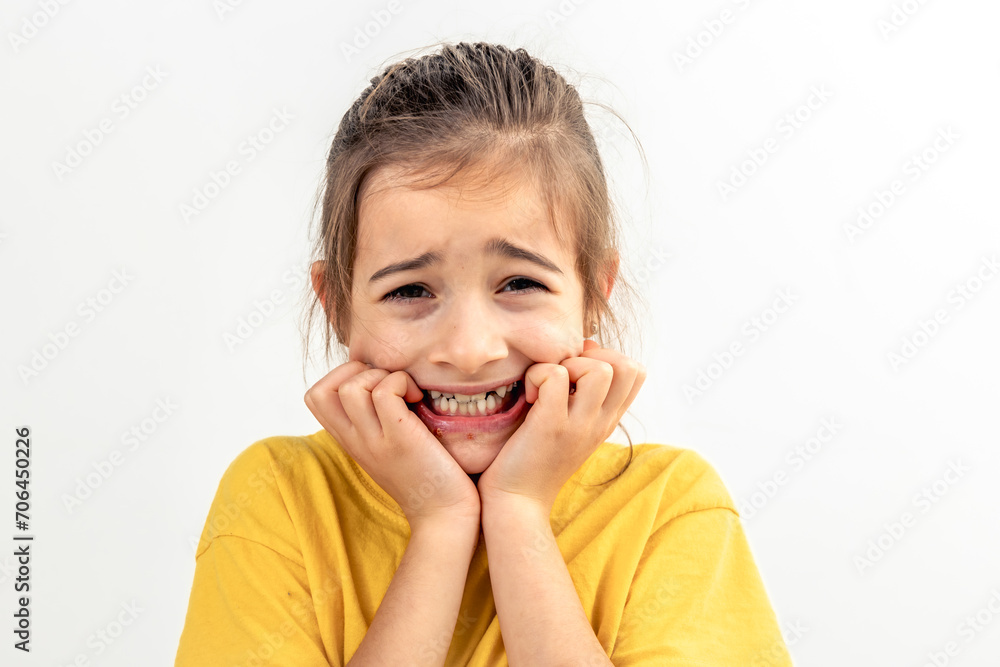 Scared and anxious girl, biting her fingernails on a white background isolated. Scared and anxious girl, biting her fingernails on a white background isolated.