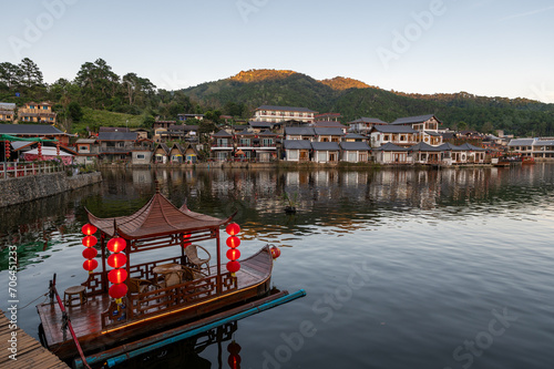 Chinese style rowing boat in the lake at Rakthai village, Mae Hong Son, Thailand photo