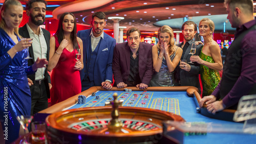 Elegantly Dressed Men and Women Enjoying Luxurious Atmosphere of a Casino. Cinematic Footage with Young People Placing Bets at the Roulette Table, Living a Lifestyle of Glamour and Entertainment