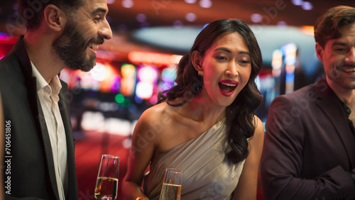 Canvas Print Attractive Multiethnic Female Taking Risks in a Casino and Celebrating a Winning Bet with Her Partner