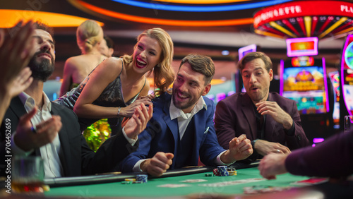 High-Stakes Poker Championship in Casino, Glamorous Players Place Bets, Reveal Cards. Player Triumphs, Celebrating His Jackpot Win against the Odds. Beautiful People Relaxing.  photo