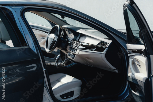 Interior of a business-class car, white perforated leather, aluminum, black lacquer, interior details. © ARTUR