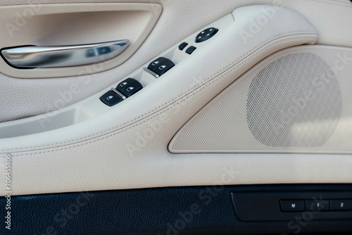 Interior of a business-class car, white perforated leather, aluminum, black lacquer, interior details.
