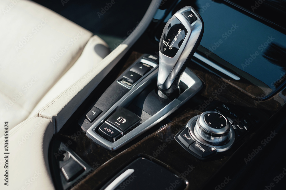 Interior of a business-class car, white perforated leather, aluminum, black lacquer, interior details.