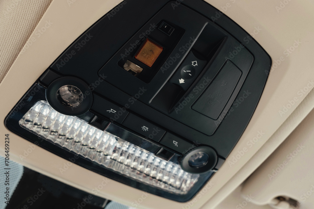 Fototapeta premium Interior of a business-class car, white perforated leather, aluminum, black lacquer, interior details.