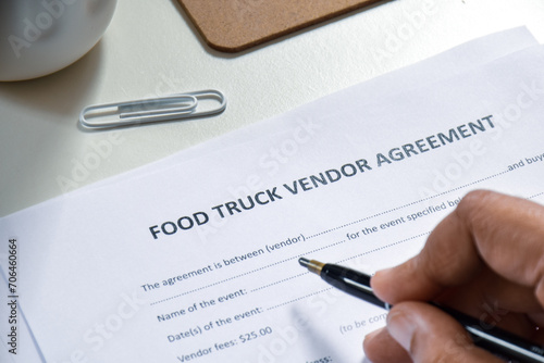 Businessman applying for Food Truck Vendor agreement application form. Selective focus.