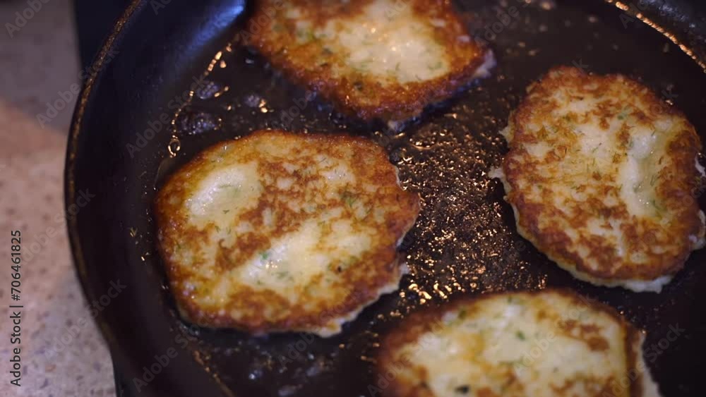 Potato pancakes are fried in a frying pan. Traditional potato dish. Vegetarian fried food Potato pancakes are fried in a frying pan. Traditional potato dish. Vegetarian fried food