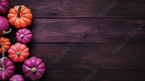 A group of pumpkins on a dark magenta color wood boards