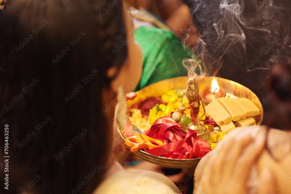 Hand holding pooja thali for indian ritual