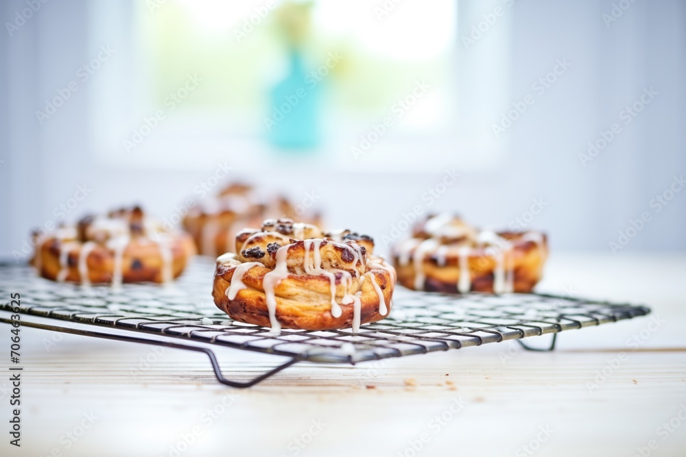 cinnamon rolls with icing on a wire rack cinnamon rolls with icing on a wire rack