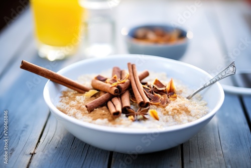 porridge with brown sugar and cinnamon sticks photo