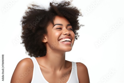 professional portrait studio photo of a handsome young afro american tatooed woman model with perfect clean teeth laughing and smiling. isolated on white background. for ads and web design 