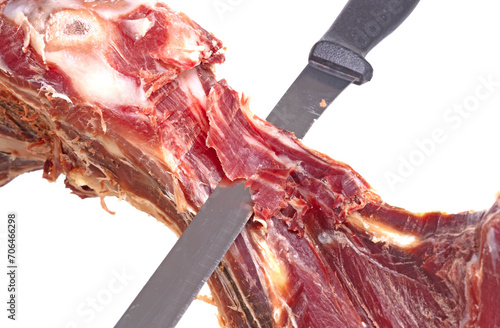 Leg of spanish jamon serrano, dry cured ham, on a white background photo