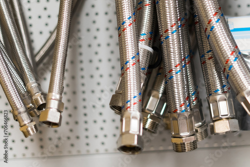 Metal plumbing thin pipes background texture. Lots of gray drain hoses