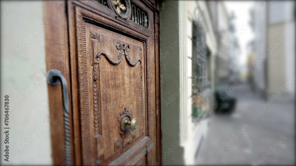 Obraz premium Ancient European door with wooden ornament, antique front entrance of residence with street