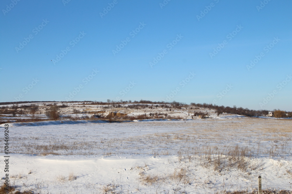 A snowy field with a blue sky