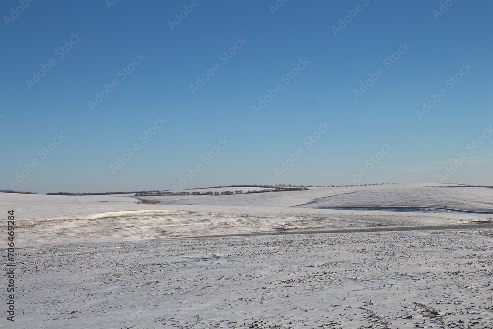 A snowy landscape with a blue sky