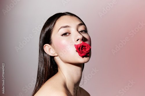 Natural Beauty: A Young Fashion Model with Red Rose, Caucasian Lady with Pretty Makeup and Sensual Look on White Background