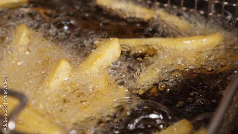 Closeup of French fries fried in boiling oil deepfried. Fast food