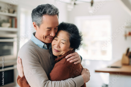 Free Download Affectionate elderly Asian couple, married for decades, share a loving embrace at home. - GFXLoad