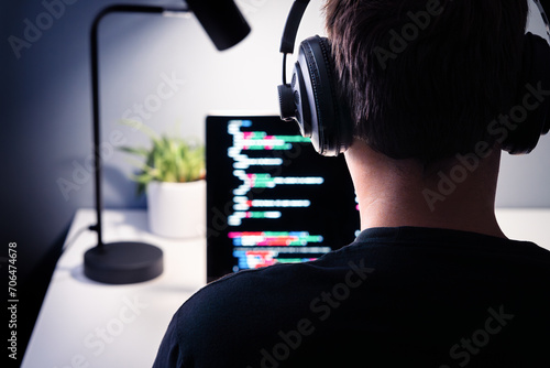 Hacker or code developer with laptop. Malware, game or website developing. Cyber criminal, programmer, engineer or coder. Fraud software or privacy security program. Spy with headphones, espionage.