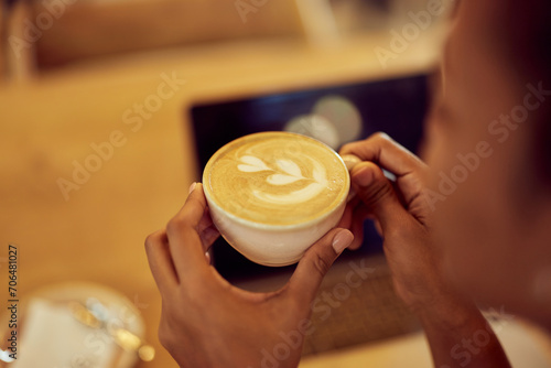 Top view of a female holding a cup of cappuccino, looking nice.