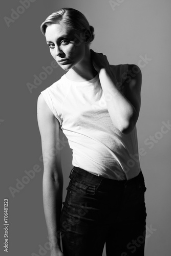 Woman, black and white in studio for vintage fashion or classic aesthetic by gray background with light. Isolated model, edgy outfit or clothes with retro style, lady or pose with art deco in studio