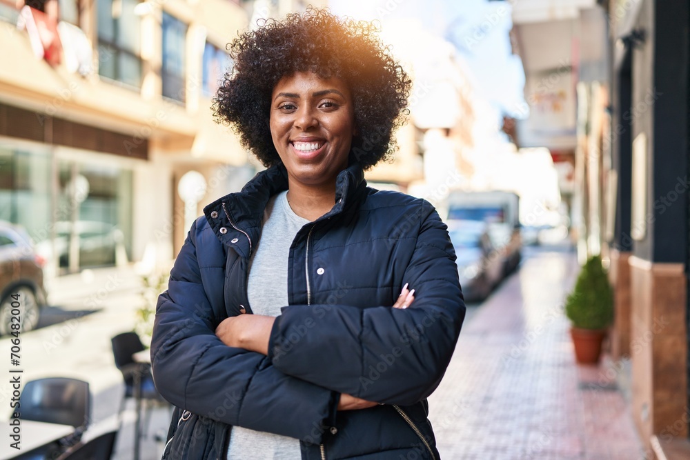 African american woman standing with arms crossed gesture at street African american woman standing with arms crossed gesture at street