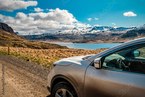 Traveling by car on the majestic landscapes in Iceland, snowy mountains and lake photo