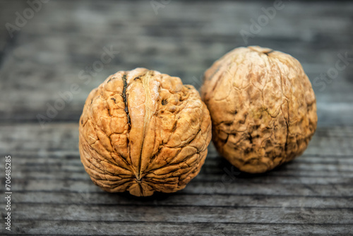 Two ripe walnut on wooden background