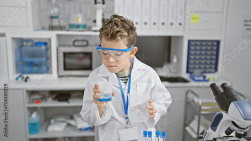 Blond boy scientist doing experiment at laboratory
