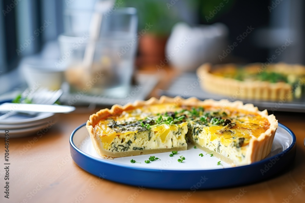 sliced quiche with melty cheese on a ceramic plate sliced quiche with melty cheese on a ceramic plate