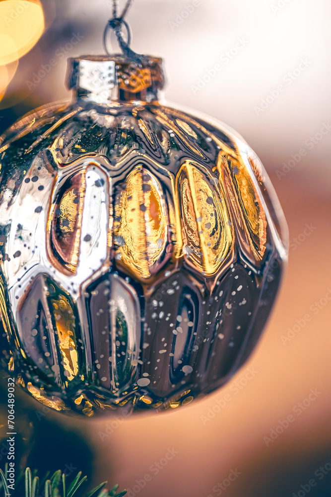 Macro shot of a silver Christmas ball on a blurred background.