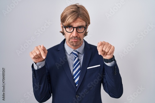 Caucasian man with mustache wearing business clothes pointing down looking sad and upset  indicating direction with fingers  unhappy and depressed.