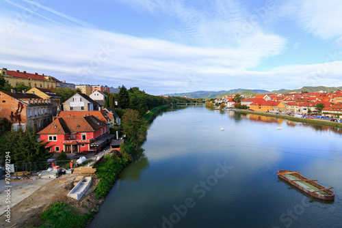 Buildings near the river Drava in Maribor city, Slovenia on a cold october morning. It was sunrise with a cloudy sky