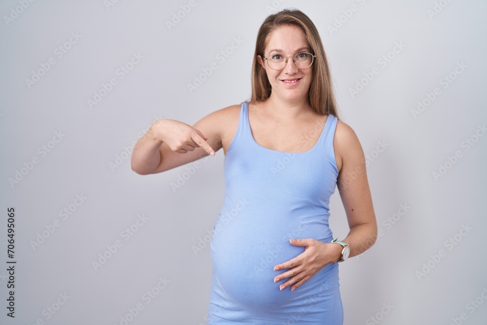 Young pregnant woman standing over white background looking confident with smile on face, pointing oneself with fingers proud and happy. Young pregnant woman standing over white background looking confident with smile on face, pointing oneself with fingers proud and happy.