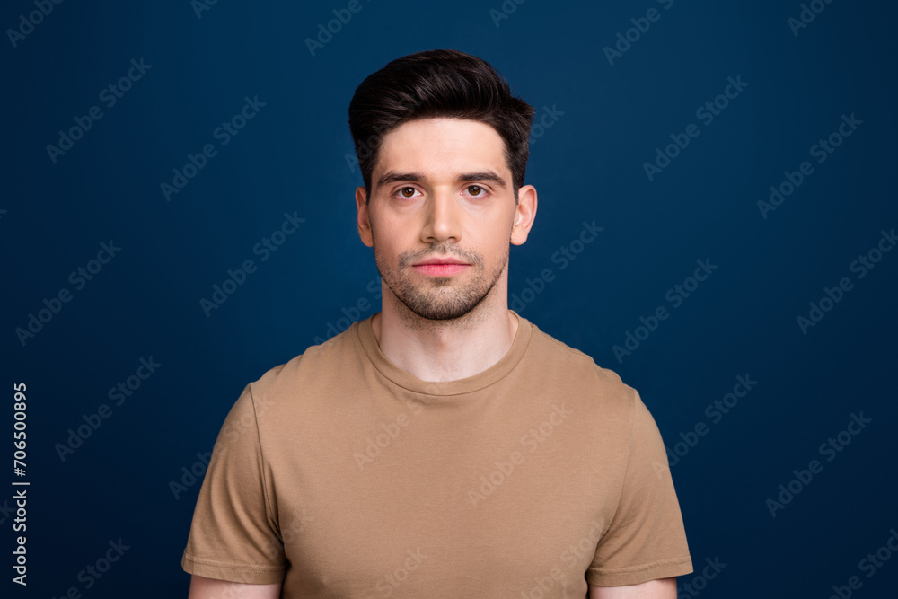 Photo of attractive virile nice man wear pastel clothes isolated on dark blue color background Photo of attractive virile nice man wear pastel clothes isolated on dark blue color background