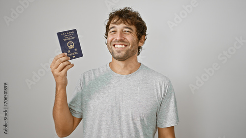 Canvas Print Young man bursting with joy holds up his passport to hong kong, exuding confiden