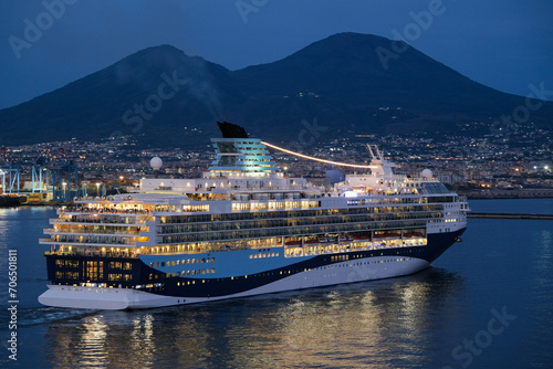 Marella cruiseship cruise ship liner Explorer 2 sail away departure from port of Naples, Italy with Vesuv volcano in background during sunset twilight hour photo
