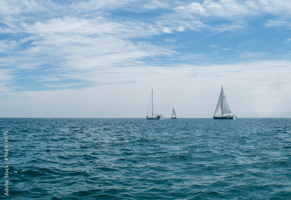 Three boats sailing on Lake Michigan on a perfect summer day.