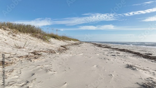 Coastline of Pawleys Island in South Carolina South of Myrtle Beach with beach houses, vacation rental real estate by Atlantic Ocean under blue sky in early morning with sunshine