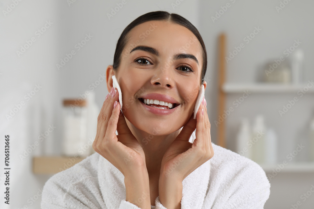 Beautiful woman removing makeup with cotton pads indoors Beautiful woman removing makeup with cotton pads indoors