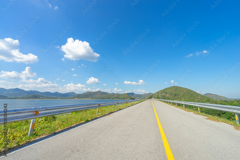 Beautiful scenic of the road in dam ridge with green grass at water dam.