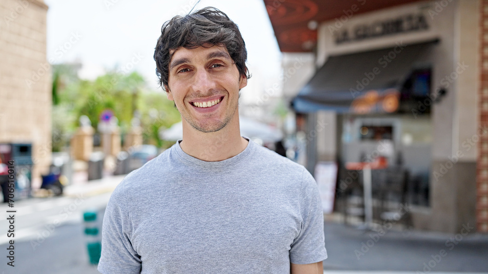 Young hispanic man smiling confident standing at street Young hispanic man smiling confident standing at street