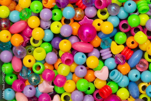 Colorful children's costume jewelry. Background of colored beads. Texture and macro image. photo