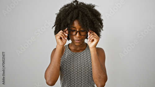African american woman business worker with serious face taking glasses off over isolated white background photo