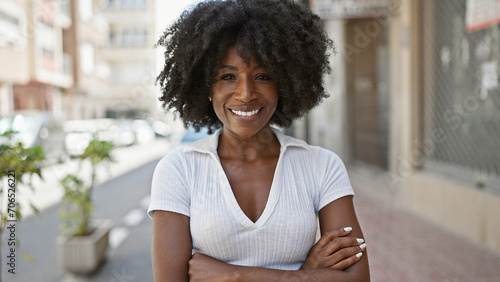 African american woman smiling confident standing with arms crossed gesture at street