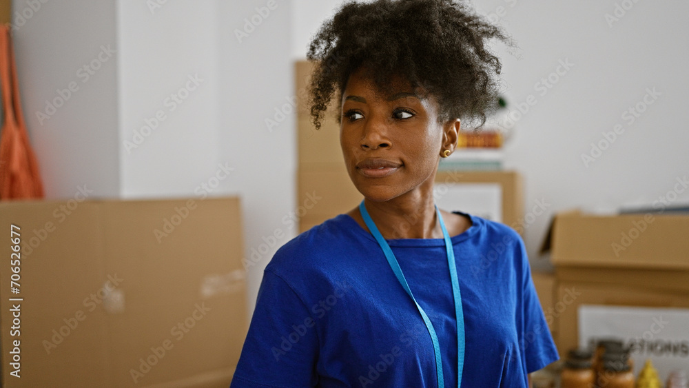 Fototapeta premium African american woman volunteer standing with serious face at charity center